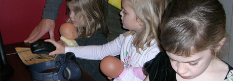 image of children with dolls and technology
